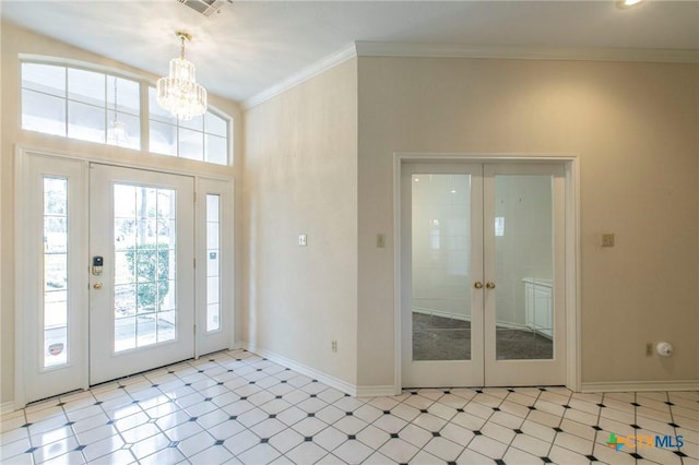 foyer featuring a notable chandelier, french doors, and ornamental molding