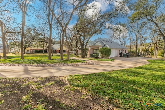 view of front of house with a garage and a front lawn