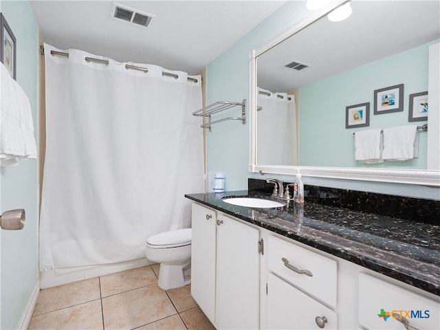full bathroom featuring toilet, vanity, tile patterned flooring, and shower / tub combo