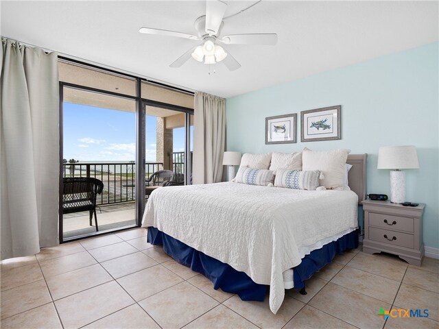 bedroom featuring access to exterior, light tile patterned floors, a wall of windows, and ceiling fan