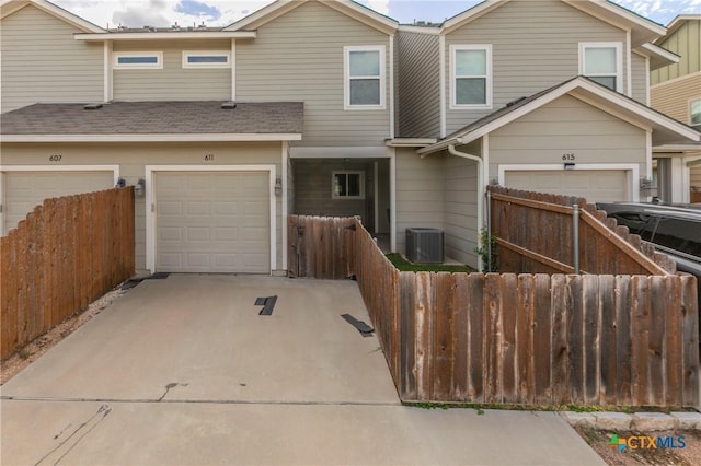 611 Westfield Blvd, Temple, TX 76502 - townhome / multi-family property featuring an attached garage, fence, driveway, and central air condition unit