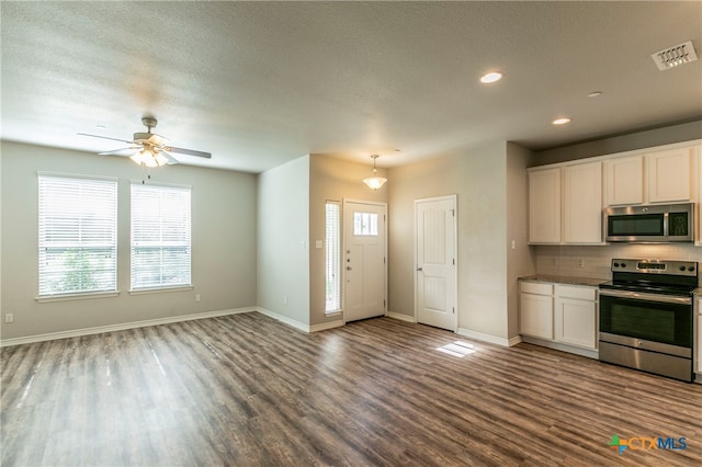 kitchen featuring hardwood / wood-style flooring, appliances with stainless steel finishes, ceiling fan, a textured ceiling, and white cabinets