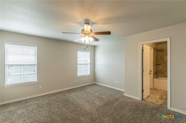 unfurnished room featuring ceiling fan, a textured ceiling, and carpet floors