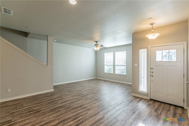 foyer featuring ceiling fan, dark hardwood / wood-style floors, a healthy amount of sunlight, and a textured ceiling