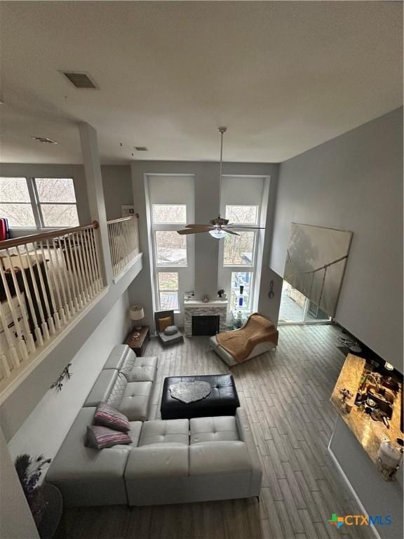 living room with wood-type flooring and ceiling fan