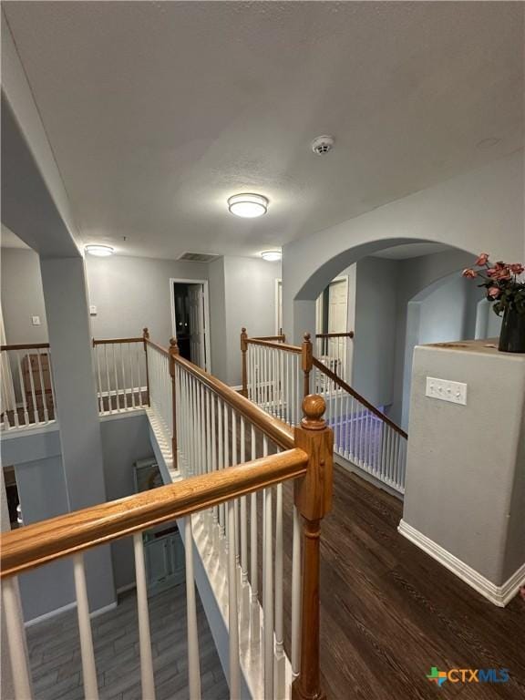 staircase with hardwood / wood-style flooring