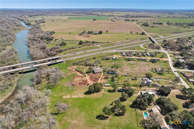 aerial view with a rural view and a water view