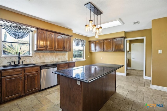 kitchen with a sink, decorative backsplash, stone tile floors, dishwasher, and baseboards