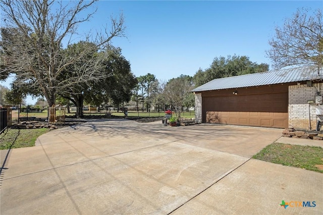 exterior space featuring fence and a detached garage