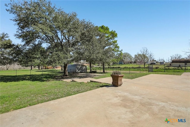 view of property's community featuring a lawn, a patio, and fence