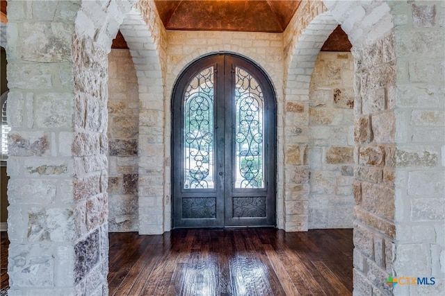 foyer entrance featuring french doors and dark hardwood / wood-style flooring