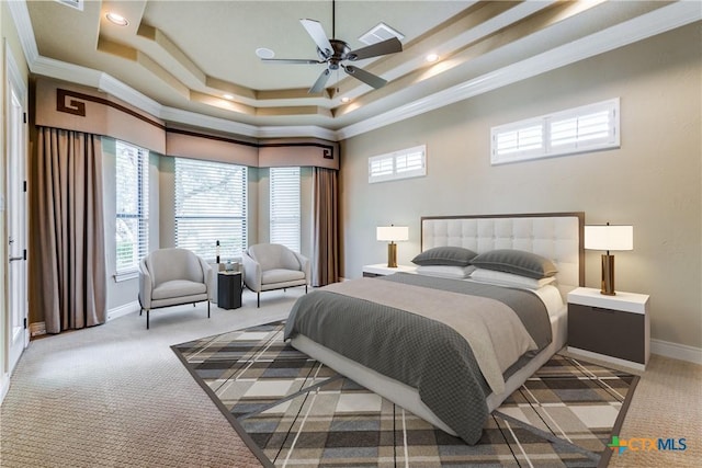 bedroom featuring ceiling fan, a raised ceiling, ornamental molding, and light carpet