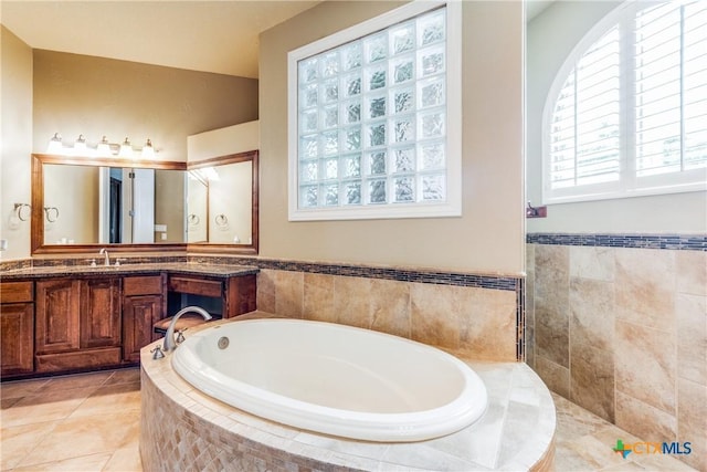 1027 Las Brisas Dr, Canyon Lake, TX 78133 - full bathroom featuring a garden tub, vanity, and tile patterned floors