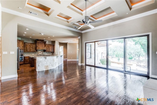 unfurnished living room with dark hardwood / wood-style flooring, coffered ceiling, ceiling fan, crown molding, and beam ceiling