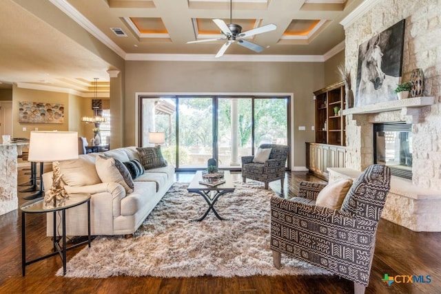 1027 Las Brisas Dr, Canyon Lake, TX 78133 - living area featuring coffered ceiling, crown molding, a fireplace, wood finished floors, and a towering ceiling