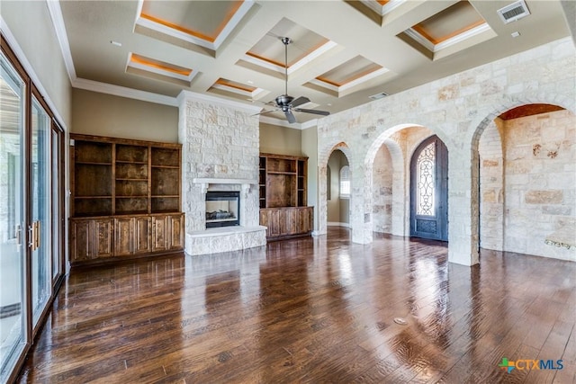 unfurnished living room featuring dark hardwood / wood-style flooring, a healthy amount of sunlight, coffered ceiling, and ornamental molding