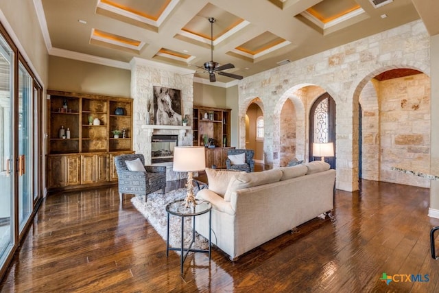 1027 Las Brisas Dr, Canyon Lake, TX 78133 - living room with coffered ceiling, crown molding, dark wood-type flooring, a large fireplace, and ceiling fan