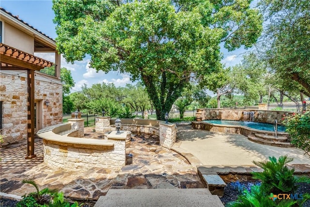 view of patio / terrace with a fenced in pool and exterior kitchen