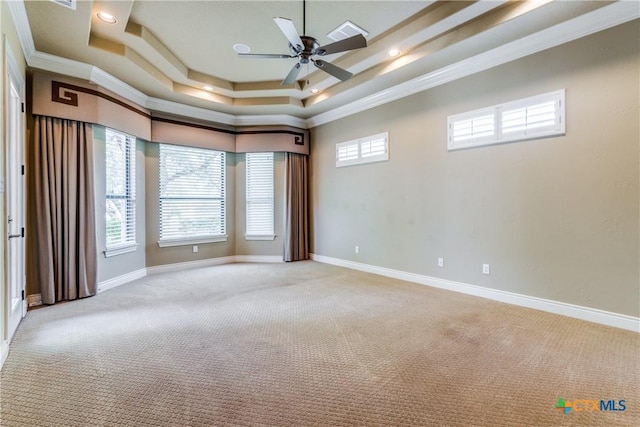 unfurnished room with a raised ceiling, crown molding, ceiling fan, and light colored carpet