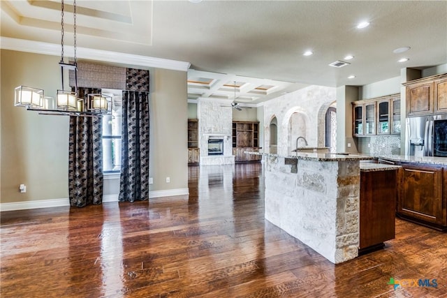 1027 Las Brisas Dr, Canyon Lake, TX 78133 - kitchen with dark wood-type flooring, a center island with sink, recessed lighting, coffered ceiling, and baseboards