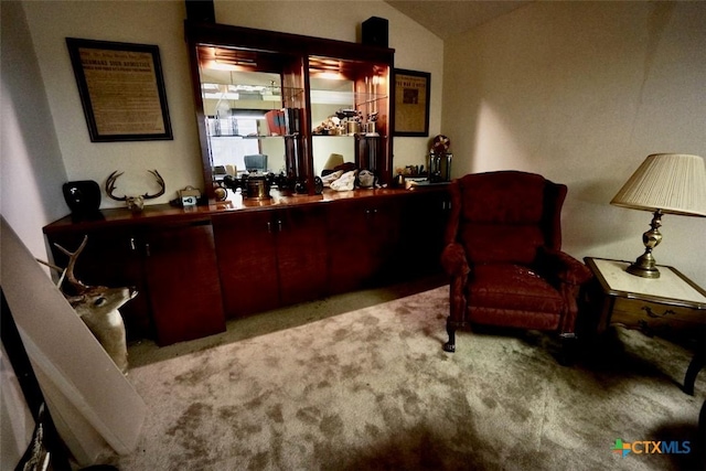 sitting room featuring light carpet and vaulted ceiling