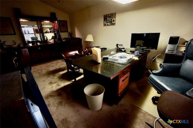 office area featuring dark carpet and vaulted ceiling