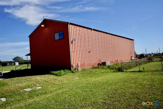 view of outbuilding with a yard