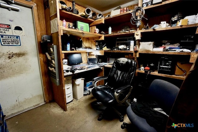 home office with crown molding and built in desk