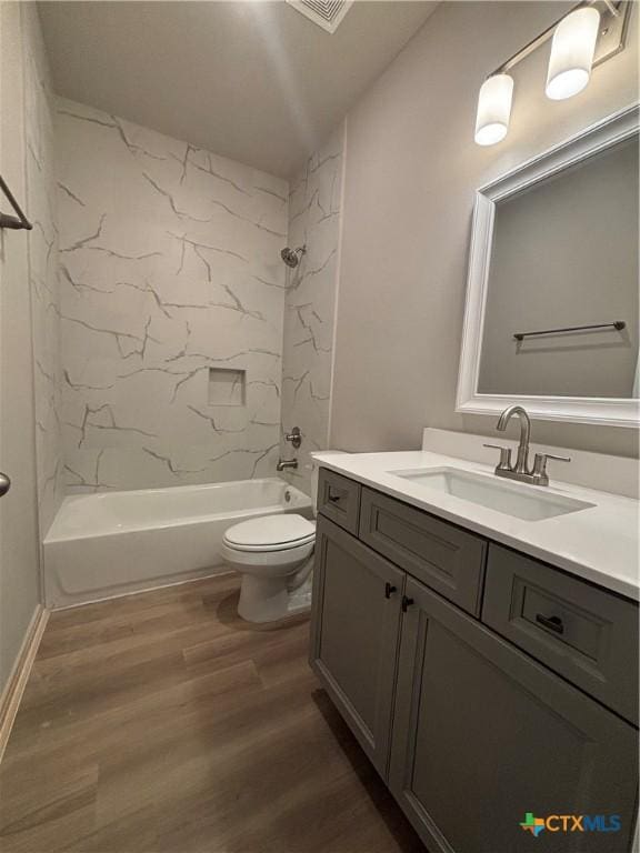 837 Swallow Dr, Palacios, TX 77465 - full bath featuring wood finished floors, toilet, vanity, and bathing tub / shower combination