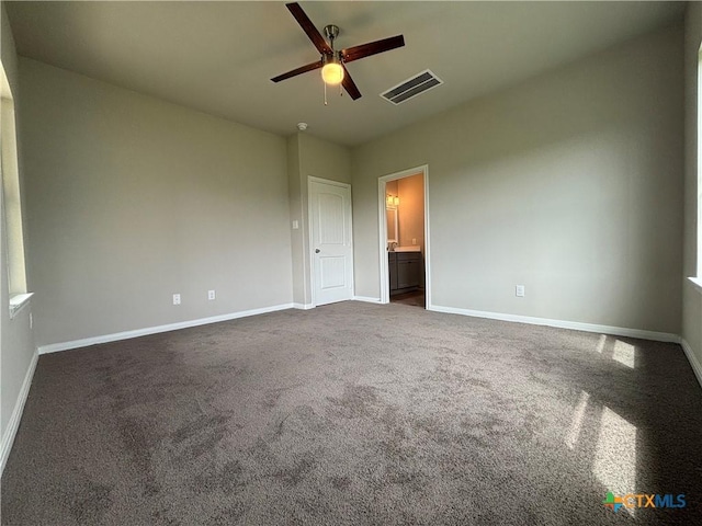 837 Swallow Dr, Palacios, TX 77465 - unfurnished bedroom featuring ceiling fan, baseboards, dark colored carpet, and visible vents
