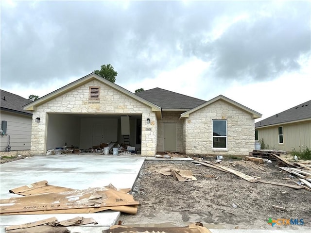 3804 Oglala Trl, Temple, TX 76502 - view of front of house with driveway, stone siding, and a garage