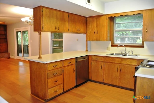 kitchen with an inviting chandelier, sink, stainless steel dishwasher, light hardwood / wood-style floors, and kitchen peninsula