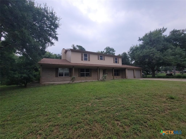 view of front of property with a garage and a front lawn