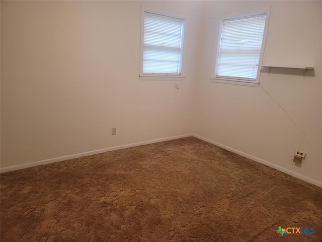 empty room with dark colored carpet