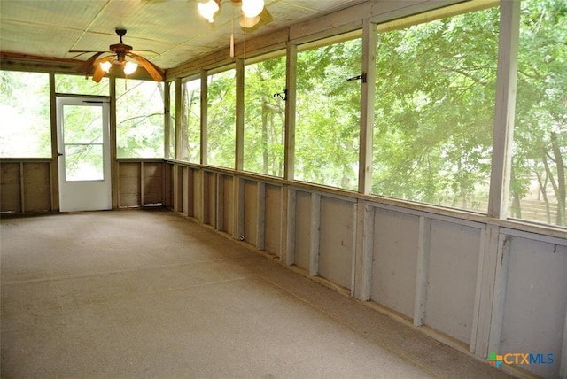 unfurnished sunroom with ceiling fan