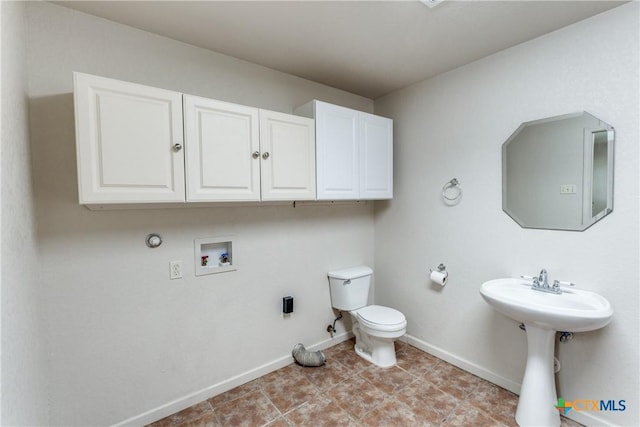 832 Saint James, Seguin, TX 78155 - bathroom featuring baseboards, toilet, a sink, and tile patterned flooring