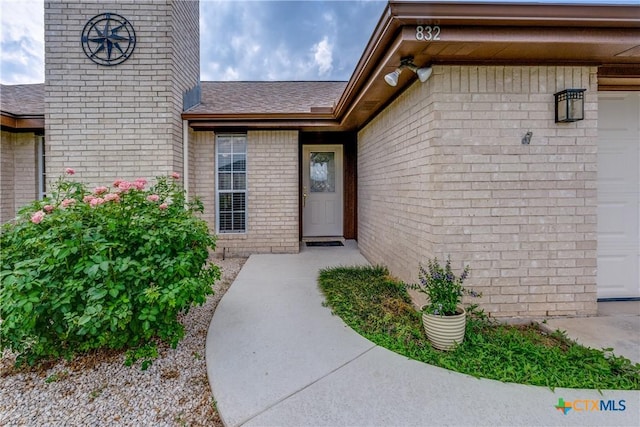 832 Saint James, Seguin, TX 78155 - view of exterior entry with brick siding and a shingled roof