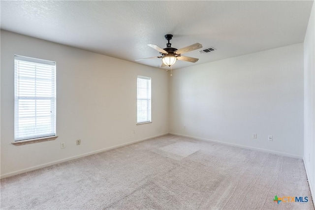 832 Saint James, Seguin, TX 78155 - spare room with light colored carpet, ceiling fan, and baseboards