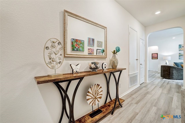 401 Thunder Valley Trl, Georgetown, TX 78626 - corridor with arched walkways, wood finished floors, and recessed lighting