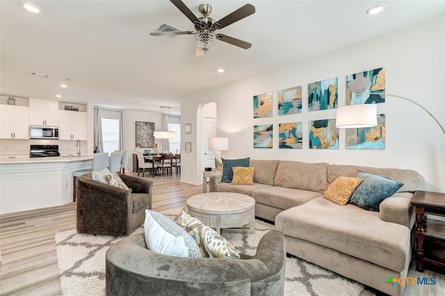 401 Thunder Valley Trl, Georgetown, TX 78626 - living area with ceiling fan, arched walkways, light wood-style floors, and recessed lighting
