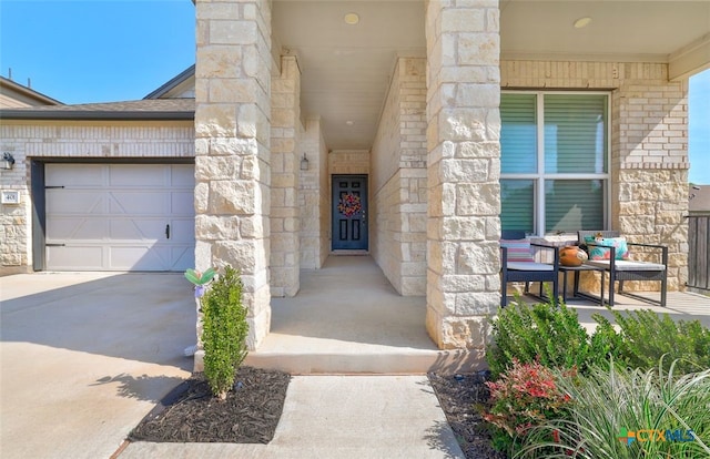 401 Thunder Valley Trl, Georgetown, TX 78626 - entrance to property with driveway, stone siding, a garage, and covered porch