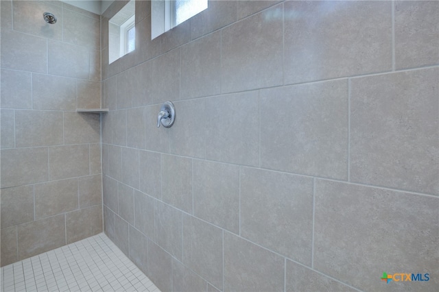 bathroom with a tile shower