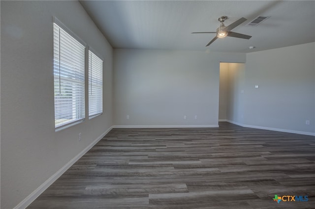 spare room with ceiling fan and dark hardwood / wood-style floors