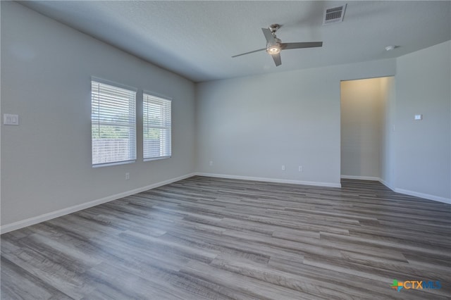 unfurnished room with ceiling fan, a textured ceiling, and light hardwood / wood-style flooring