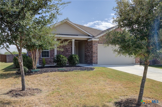 view of front of home featuring a front yard and a garage