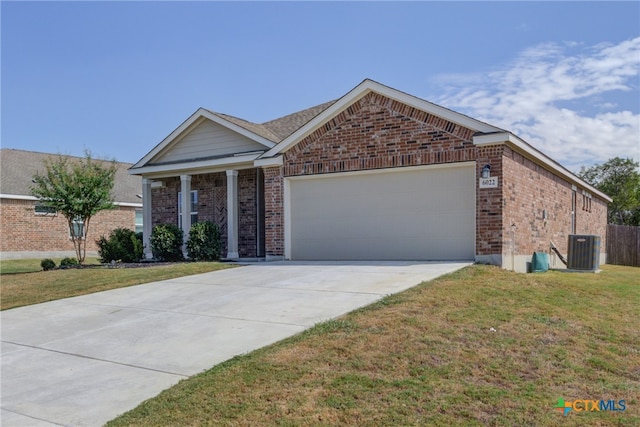 ranch-style home featuring central AC unit, a garage, and a front lawn