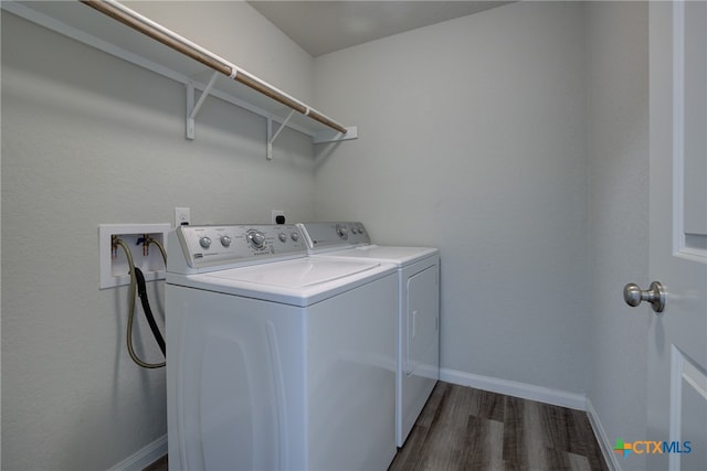 laundry room featuring dark wood-type flooring and washing machine and clothes dryer