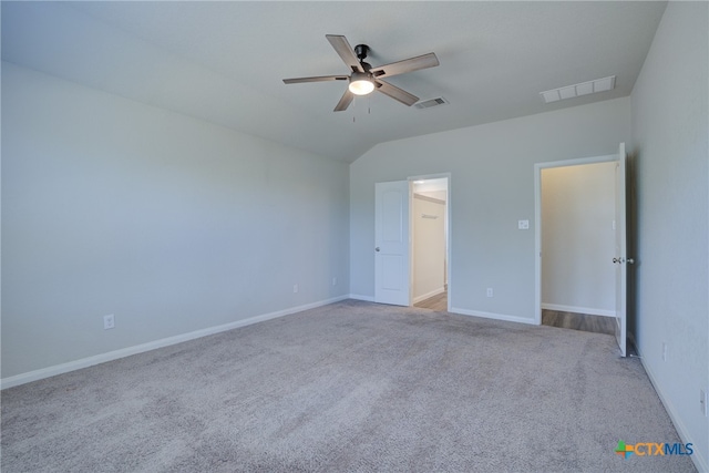 unfurnished bedroom featuring vaulted ceiling, light carpet, and ceiling fan