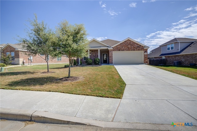 view of front facade featuring a garage, central AC unit, and a front yard