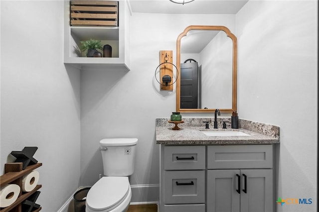 1611 Port Lavaca Dr, Victoria, TX 77901 - half bathroom featuring vanity, toilet, and baseboards